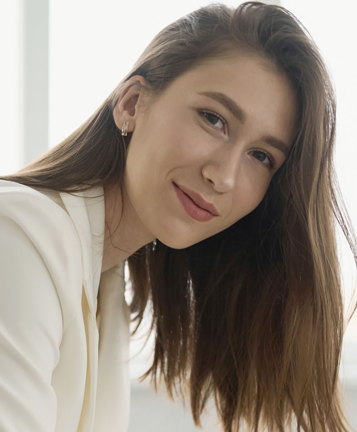 Portrait of a smiling woman with long hair.