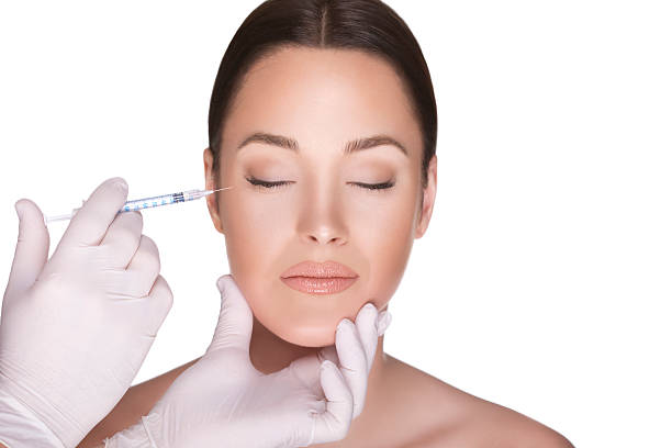 injecting dermal fillers to female patient